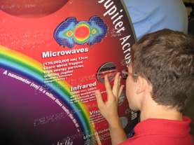 A visitor examines the SSREK tactile graphics