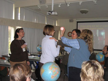 Teachers touch a tactile ball to explore the phases of the moon by touch